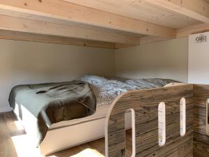 a bed in a room with a wooden ceiling at Tiny Haus Park Fritzlar in Fritzlar