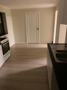 an empty kitchen with a door to a room at Familyroom #1 Appartmenthotel Oslo Adress Isabels vei 16 in Oslo