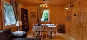 a dining room with a table and chairs in a room at Casa NOR in Tarcău-Gheuca