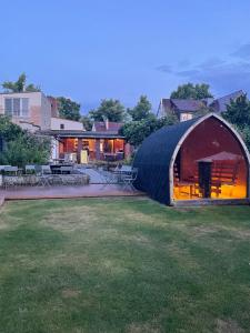 a large black dome tent in a yard at Haus am See in Schwielowsee