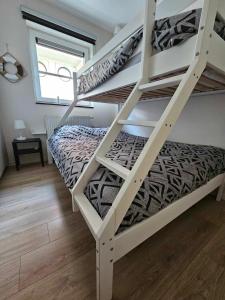 a bedroom with two bunk beds in a room at Sailors Beach VI Villa Jalina verwarmd zwembad in het hoogseizoen in Nieuwpoort