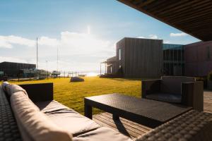 a patio with a couch and a table and a building at Kaluri Seaview Apartment in Kuressaare