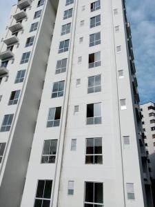 a tall white building with many windows at Cozy Apartment in Pinares de San Martin. ¡PEREIRA! in Pereira