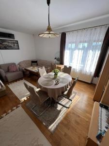 a living room with a table and chairs at Becehegyi Vendégház in Balatongyörök