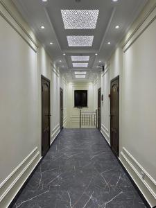 a hallway with white walls and a ceiling at Hello Dushanbe Hostel in Dushanbe