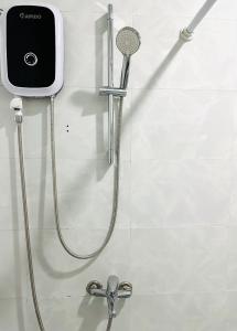 a shower with a shower head in a bathroom at Cozy & Quiet 1BR Oasis in the heart of Ho Chi Minh City in Ho Chi Minh City