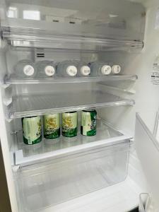 an open refrigerator filled with cans of soda at Cozy & Quiet 1BR Oasis in the heart of Ho Chi Minh City in Ho Chi Minh City