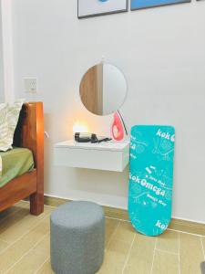 a room with a bed and a stool and a mirror at Cozy & Quiet 1BR Oasis in the heart of Ho Chi Minh City in Ho Chi Minh City