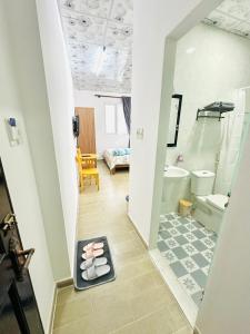 a hallway with a bathroom with a tub and a toilet at Cozy & Quiet 1BR Oasis in the heart of Ho Chi Minh City in Ho Chi Minh City