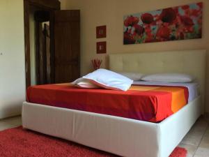 a bedroom with a bed with a colorful blanket at B&B Villa Lura Pompei in Pompei