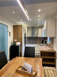 a kitchen with a wooden table and a dining room at Ian's Residence in Kranjska Gora