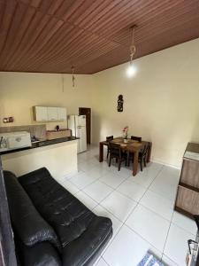 a living room with a couch and a table and a kitchen at Recanto da Serra in Pardinho