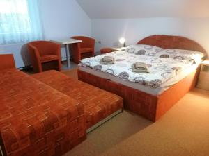 a bedroom with a bed and a table and chairs at Apartmány AQUAVILLA in Liptovský Trnovec