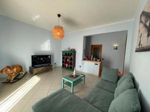 uma sala de estar com um sofá e uma televisão em SEA4USALERNO seafront em Salerno