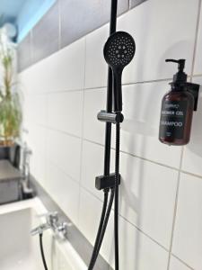 eine Dusche im Bad mit schwarzem Duschkopf in der Unterkunft Doppelzimmer 1 I geteiltes Bad & Küche I mit dem Zug nur 4 min bis zum Hauptbahnhof in Freiburg im Breisgau