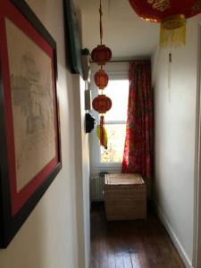 a hallway with a window and a bench in a room at Ker Anna in Athis-Mons