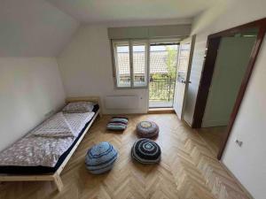 a room with two beds and mats on the floor at Tiny Bled house in Bled