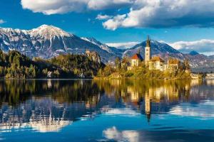 a church on an island in the middle of a lake at Tiny Bled house in Bled