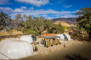 an aerial view of three domes in a field at Sequoia Studio Suites in Three Rivers