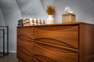 a wooden dresser with two vases on top of it at Sequoia Studio Suites in Three Rivers