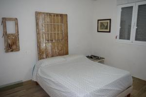 1 dormitorio con cama y ventana abierta en The white house, 