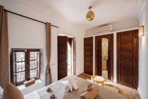 a bedroom with a bed with two towels on it at Riad of the Moon in Marrakesh