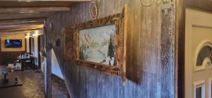 a painting on the wall of a room at PENSIUNEA Mari Haus in Poiana Mărului