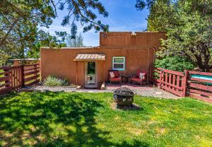 una piccola casa con recinzione e patio di Pet Friendly Piñon Heaven a Santa Fe
