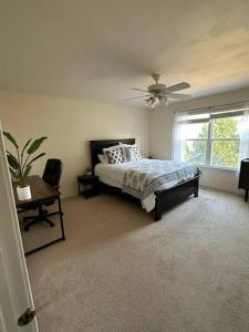 a bedroom with a bed and a ceiling fan at Family home on fescue in Aurora