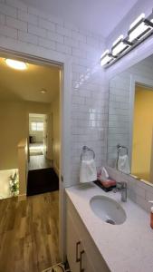 a bathroom with a sink and a mirror at Classy single family house, walk to St Boniface in Winnipeg