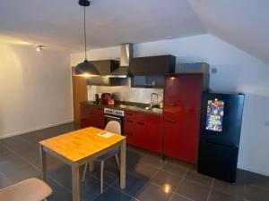 a small kitchen with a red refrigerator and a table at Schnuggeliches Apartment in Gerbrunn