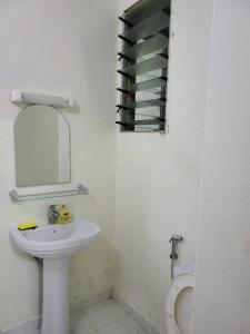 a bathroom with a sink and a mirror and a toilet at Jado house 4 in Dakar