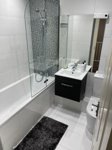 a bathroom with a shower and a sink and a toilet at Crestfield Lodge in Thamesmead