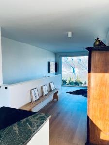 a living room with a table and a large window at Panorama View - CharmingStay in Flumserberg +7 photos