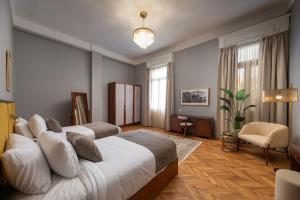 a hotel room with two beds and a chair at Lemon Spaces VINTAGE- Downtown in Cairo