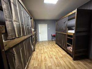 a room with black lockers and a wooden floor at ArArAt-POZNYAKI Hostel KYIV in Kyiv