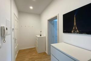 a white room with a picture of the eiffel tower at Chez Amis Arena in Leipzig