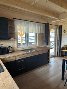 a kitchen with a sink and a window at Osada Wichrowe Wzgórze in Rajcza