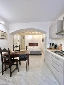 a kitchen and living room with a table and a bed at ADG Apartment 33 in Florence