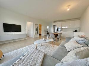 een woonkamer met een bank en een tafel bij Cosy stay with a great view! in Njarðvík