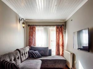 a living room with a couch in front of a window at Private mansion in kumkapı in Istanbul