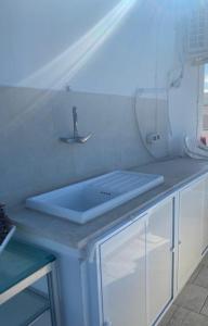 - un comptoir de cuisine avec un évier et un miroir dans l'établissement A un passo dal mare, à Villanova di Ostuni