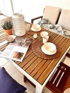 a wooden table with plates and dishes on it at ADI BOUTIQUE HOUSE in Thessaloniki +103 photos