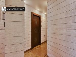una puerta en un pasillo con paredes de madera en Super Townhouse Acme Near Park Street, en Calcuta