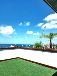a balcony with a view of the ocean at Hotel Los Algarrobos in Puerto Baquerizo Moreno