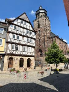 ein großes Gebäude mit einem Turm mit einem Baum davor in der Unterkunft Schloßbergwohnung Löwenhaus in Homberg