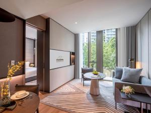 a living room with a couch and a table at Fraser Residence River Promenade, Singapore in Singapore