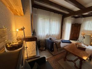 a living room with a couch and a table at Crans-Montana Duplex Lodge in Crans-Montana