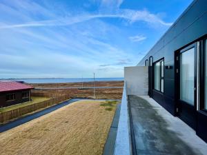 a house with a view of the ocean at Cosy stay with a great view! in Njarðvík