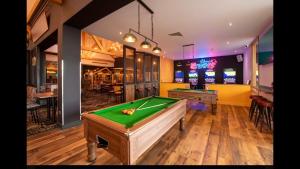 a room with a pool table and arcade games at 8 Birth Mobile Luxury home C016 8SG St Osyth near Clacton on Sea in Clacton-on-Sea